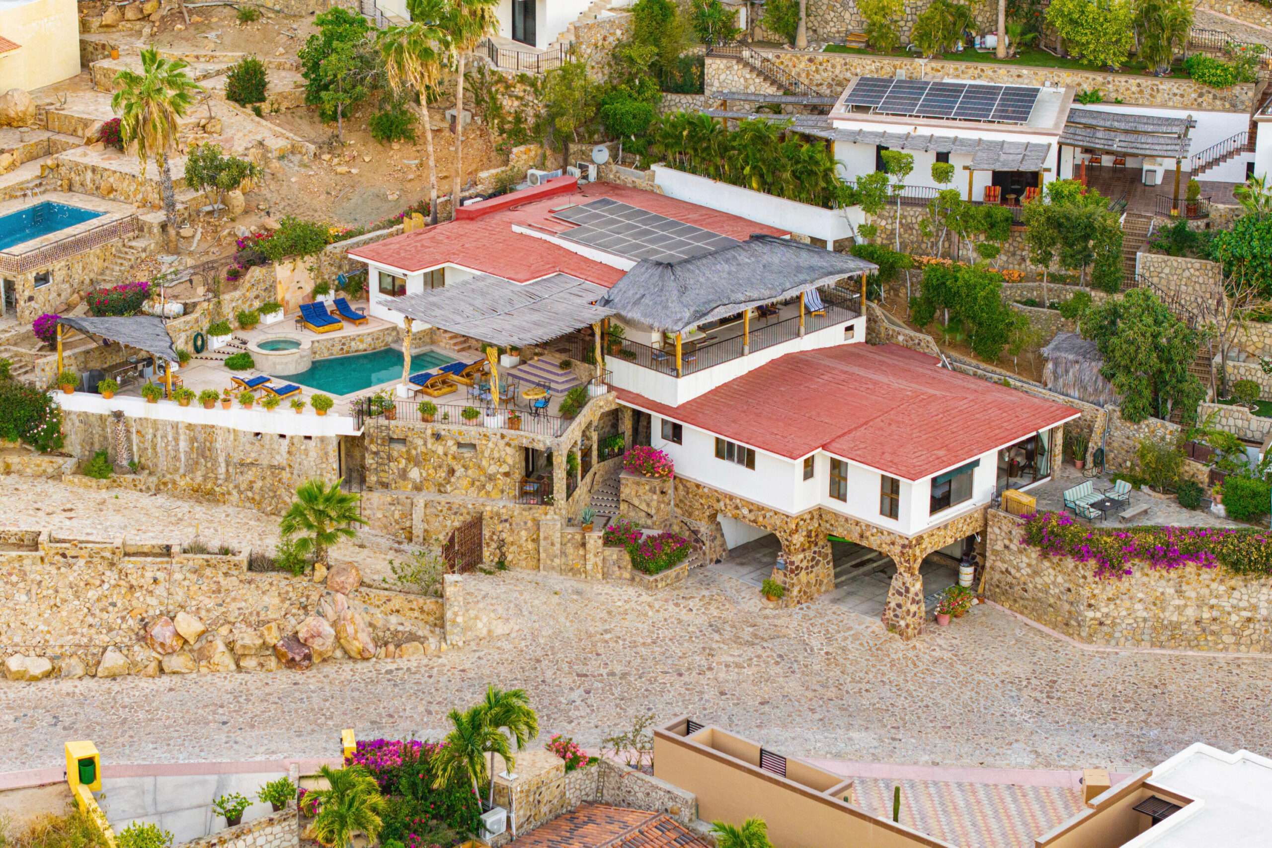 Los Cabos Los Valles Sophisticated and solidly built, this 5,588 sq.ft. estate in Club Campestre offers luxury living with exceptional construction quality rarely found in Los Cabos. Residents enjoy exclusive access to a private beach club and world-class golf course, all just minutes from San Jose vibrant dining and culture. The home features 4 ensuite bedrooms, a 3-stop elevator, and a Generac backup system. Entertain in style with a chef's kitchen, wine room with Tzalam wood cabinetry, and an outdoor BBQ area with fire pit. Relax by the heated pool or on the Jacuzzi terrace with partial ocean – Costa Villa 103, C. Barrancas, Cabo San Lucas, BS