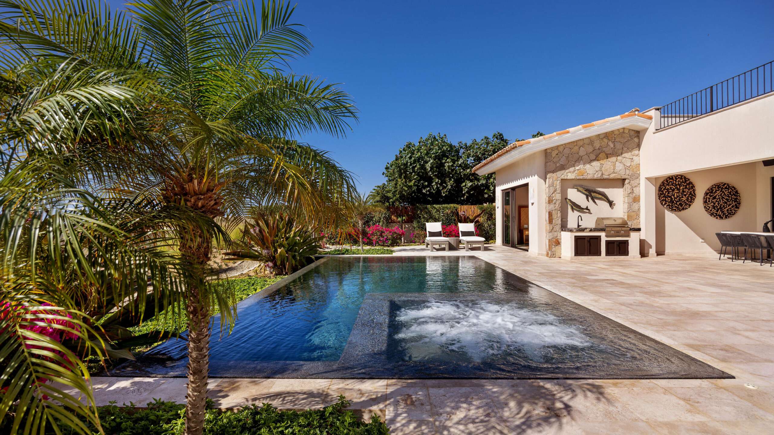 Los Cabos Los Valles Sophisticated and solidly built, this 5,588 sq.ft. estate in Club Campestre offers luxury living with exceptional construction quality rarely found in Los Cabos. Residents enjoy exclusive access to a private beach club and world-class golf course, all just minutes from San Jose vibrant dining and culture. The home features 4 ensuite bedrooms, a 3-stop elevator, and a Generac backup system. Entertain in style with a chef's kitchen, wine room with Tzalam wood cabinetry, and an outdoor BBQ area with fire pit. Relax by the heated pool or on the Jacuzzi terrace with partial ocean – Costa Villa 103, C. Barrancas, Cabo San Lucas, BS